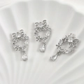 Macro detail of 14k gold-plated bow heart pendant with sparkling cubic zirconia stones - White K Hollow Butterfly Wreath Water Drop (Clear Zirconia)