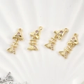 Macro detail of 14k gold plated fishbone pendants with pink zircon for DIY jewelry - Gold