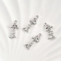 Detailed macro of four 14k gold plated fishbone pendants with pink cubic zirconia - Silver