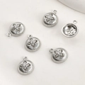 Detailed macro view of six silver starburst pendants with clear cubic zirconia stones - White Gold Domed Zirconia Starburst (Size 8)