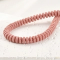 Macro detail of pink porous lava stone spacer beads for DIY jewelry making - 4*8mm / Pink