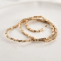 Close-up of gold-plated large hoop earrings featuring textured cubic beads and stud closure - KC Gold (2mm)