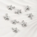 Macro detail of eight silver star pendants with sparkling cubic zirconia for DIY jewelry - The Star (6#)