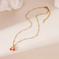 Detail of 18K gold-plated cherry pendant necklace with beaded chain on retro background - Cherry Necklace Style A (25WN034)