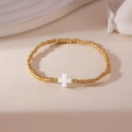 18K gold plated bead bracelet with white cross charm on minimalist cream background - Gold Cross