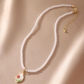 Detail of red rose pendant on a multi-layer pearl necklace with a gold clasp - White with Red Flower