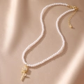 Detail of multi-layer pearl necklace with a gold rose pendant and lobster clasp closure - White Rose
