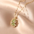 Macro detail of crescent moon and flower gold pendant necklace on satin fabric - Orange
