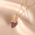 Detailed macro view of purple gemstone grape pendant on a fine gold stainless steel chain - Grapes