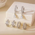 Detailed view of silver hoop earrings with waterdrop and square cubic zirconia on stone base - 3 Pairs Set / Silver