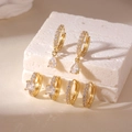 Detailed view of three gold-plated copper hoop earrings with square and teardrop zircons - 3 Pairs Set / Gold White