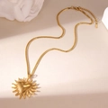 Detailed view of gold sun heart pendant on mariner chain with lobster clasp and extender - Sun Heart