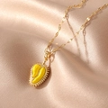 Unique gold plated durian pendant necklace with yellow enamel on a satin background - Durian
