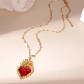 Detail of red enamel heart pendant with golden flame on minimalist stainless steel chain - Sacred Heart
