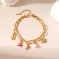 Detail of double-layer stainless steel gold bracelet with sea creature charms and lobster clasp - Red Starfish
