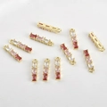 Close-up of 14k gold-plated bamboo pendants with gradient pink zircon for jewelry making - 14k金底粉色渐变款
