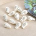 Close-up of white teardrop baroque imitation pearls with iridescent luster for DIY jewelry - 12*23mm