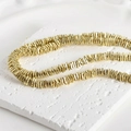 Detailed view of 4mm gold-plated volcanic stone spacer beads for DIY jewelry making - Light gold