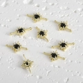 Macro detail of 14k gold plated starburst connector with black stone and white zircon - Gold-Black