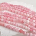 Detailed macro view of 8mm natural Persian jade round beads in soft peach pink hues - Peach Pink 10mm (Approx. 36 Beads)