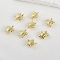 Macro view of 8 gold-plated turtle beads with detailed shells for DIY jewelry making - Sea Turtle / 14K Gold