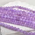 Macro shot of 8mm polished lavender Persian jade round beads on a white marble stone base - Lavender Purple 10mm (Approx. 36 Beads)