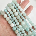Detailed view of hand-held light blue natural stone round beads for DIY jewelry making - Amazonite Blue 6mm (Approx. 58 Beads)
