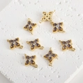 Detail of gold-plated four-leaf flower connectors with purple and white cubic zirconia - Purple