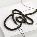Macro detail of natural dark obsidian abacus beads showing smooth texture on stone surface - 13# Abacus Bead Style / 2x4mm (160 Pieces/Pack) / Golden Obsidian