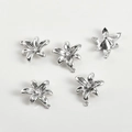 Macro shot of five silver floral pendants with central zircon for jewelry making - White Gold Large Flower Style