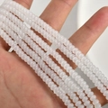 Macro shot of 2x4mm translucent white glass rondelle spacer beads for DIY jewelry making - White Jade