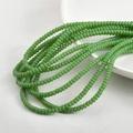 Detailed view of 2x4mm glossy green glass spacer beads for DIY jewelry making - Porcelain Green
