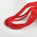 Macro shot of 2x4mm bright red disc glass beads for handmade jewelry DIY projects - Porcelain Red