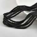 Macro shot of 2x4mm black glass spacer beads for DIY jewelry and bracelet making - Black
