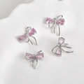 Detail of four 14k gold-plated bow pendants with pink zircon stones on a ceramic tray - 8# Pink Zirconia Double Layer Bow White K