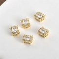 Close-up of 14K gold plated rectangular zircon beads with hollow side patterns - White Zirconia Square 14k Gold