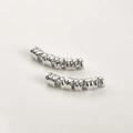 Close-up of spiral metal tube beads for DIY jewelry and hair braid accessories - Wire Wrapped Curved Tube / Silver