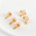 Macro shot of pink jade charms with 18k gold rose-engraved caps for jewelry making - Grapefruit Pink