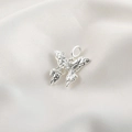 Detailed macro view of silver butterfly pendant with liquid metal lava texture and gemstone - Silver