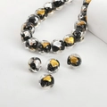Detailed macro of handmade glass beads with gold foil and silver leaf inside - Black Square #9
