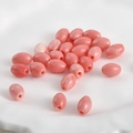Macro detail of pink coral-style pumpkin beads with center hole for DIY jewelry making - Style 3 Rice Smooth Bead (Approx 10.8x7.7mm Hole 1.5mm)