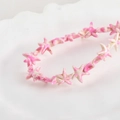 Detailed close-up of pink and white synthetic starfish beads on a white ceramic plate - Pastel Pink Starfish