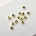 Macro view of heart-shaped olive green zircon charms with 14k gold plated beaded frames - Olive Green Zirconia