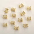 Macro detail of 14k gold plated bow-shaped spacer beads with sparkling zircon stones - 14K Gold Vase Style