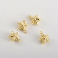 Detailed macro view of four gold starfish charms for DIY jewelry making and crafts - 14K Gold Starfish (10x9mm)