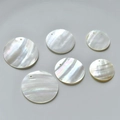 Close-up of circular natural mother of pearl shell pendants with pre-drilled holes - 15# White Shell (25mm)
