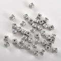 Macro shot of silver square smiley face spacer beads for DIY jewelry making and crafts - White Gold Smiley Square (3.9mm Hole 1.2mm)