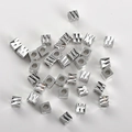 Macro shot of silver plated square spacer beads with diamond-cut facets for DIY jewelry - White Gold Engraved Square (4mm Hole 2.2mm)