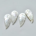Detailed view of iridescent mother of pearl leaf charms for DIY jewelry making - Long Leaf Left Style