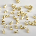 Macro shot of 14k gold-plated cylinder beads with spiral wave texture for DIY jewelry - Approx 5x3mm / 14K Gold
